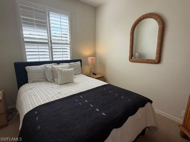 Carpeted bedroom featuring baseboards