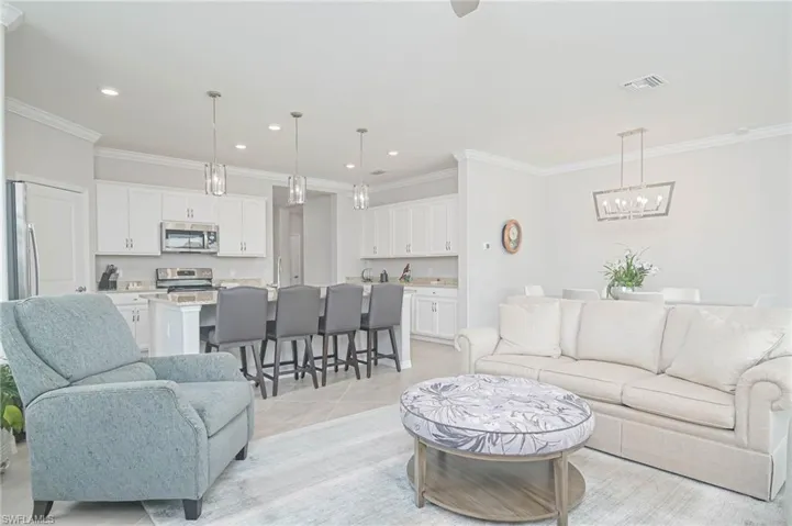 Tiled living room featuring crown molding