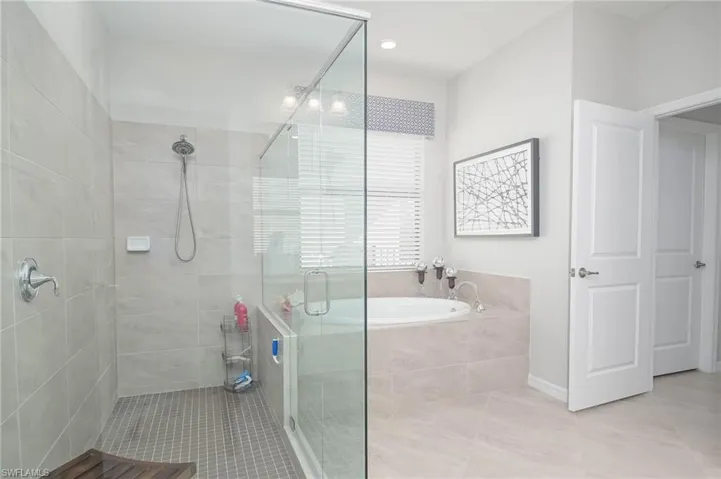 Bathroom with plus walk in shower and tile patterned floors