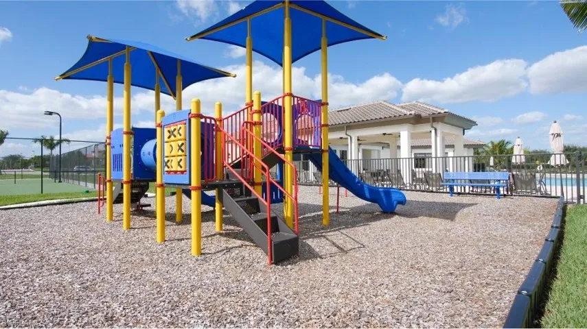 View of jungle gym with a community pool