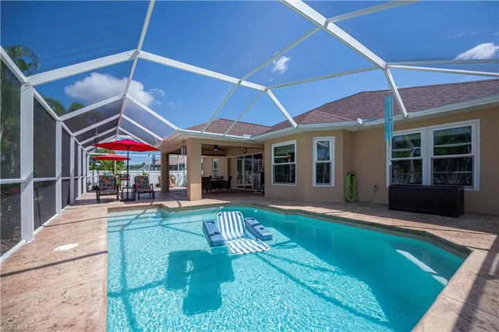 Pool looking towards covered lanai and extended lanai area
