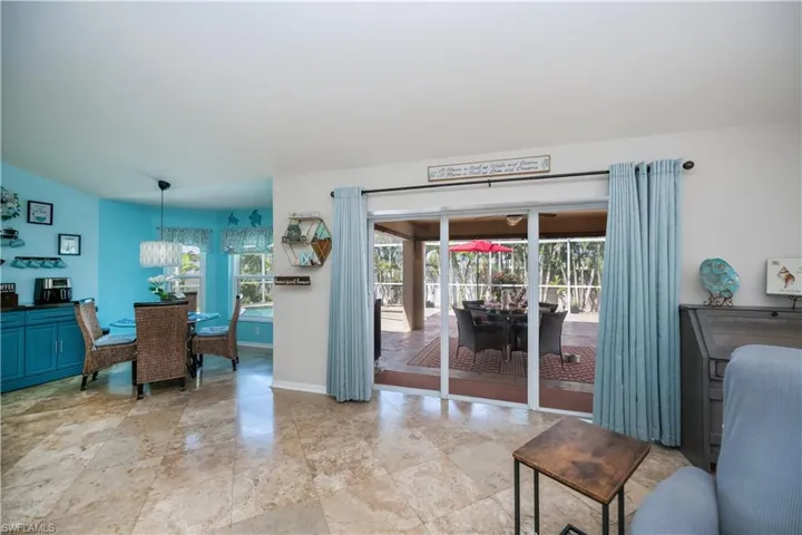 great room looking out to lanai and eat in kitchen area