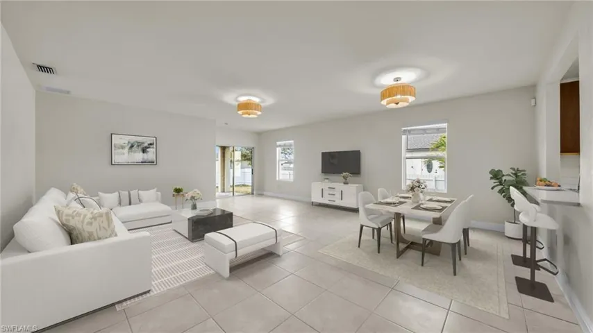Living room with plenty of natural light and light tile patterned floors