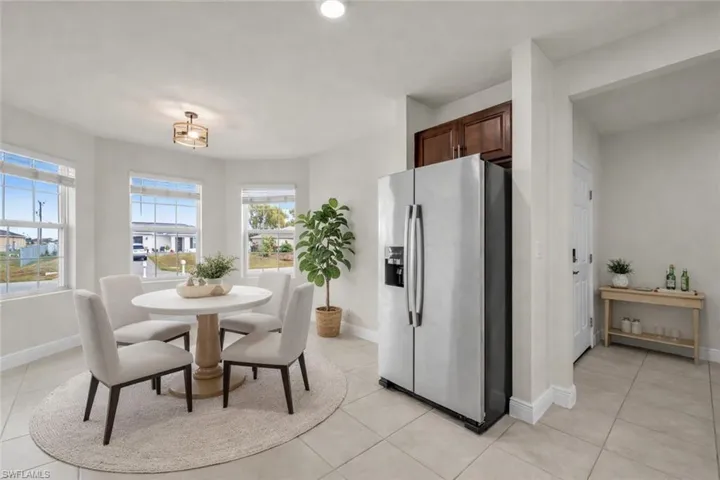 Dining room featuring baseboards and light tile patterned flooring
