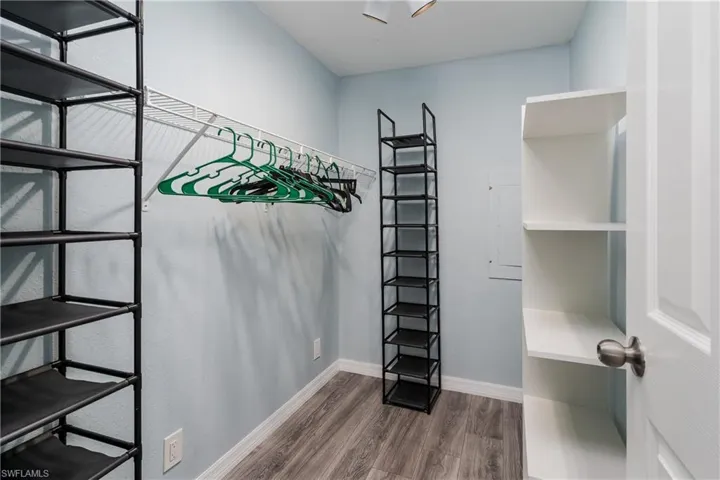 Walk in closet featuring wood finished floors