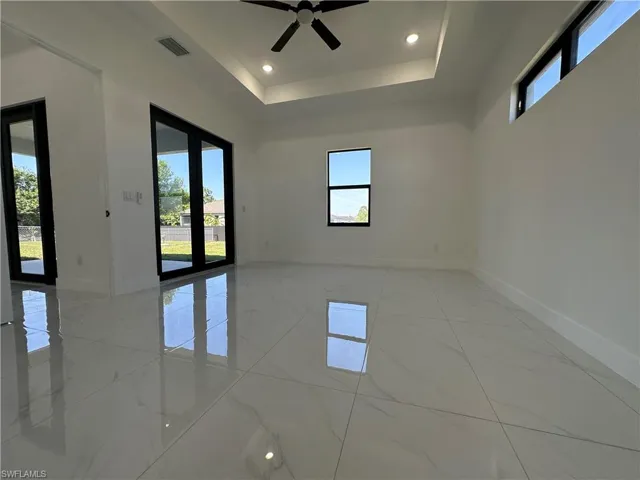 Empty room with visible vents, baseboards, and marble finish floor