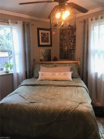 Bedroom with multiple windows and ceiling fan