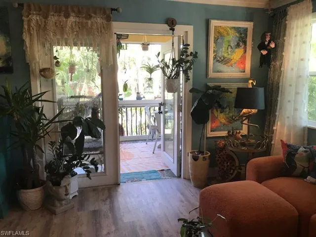Doorway to outside featuring hardwood / wood-style flooring and a wealth of natural light