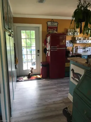 Entryway featuring hardwood / wood-style flooring and crown molding