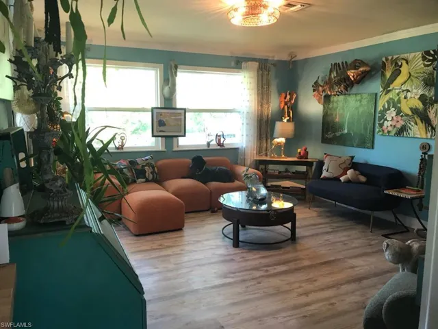 Living room featuring crown molding and hardwood / wood-style floors