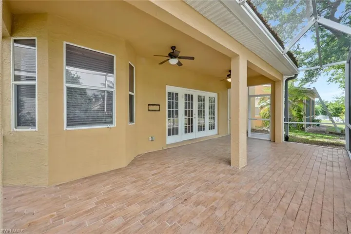 View of patio / terrace featuring a lanai, french doors, and a ceiling fan