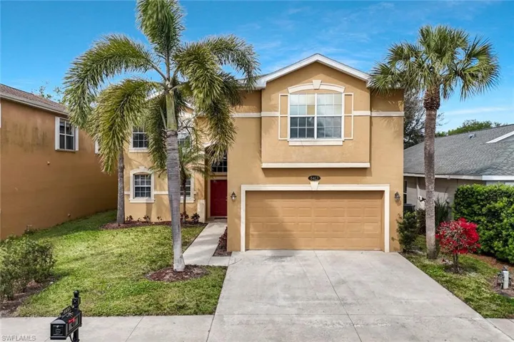 View of front of property with a garage, driveway, stucco siding, and a front lawn