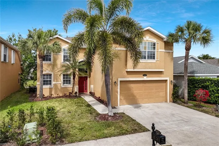 View of front of house featuring a garage, concrete driveway, stucco siding, and a front lawn