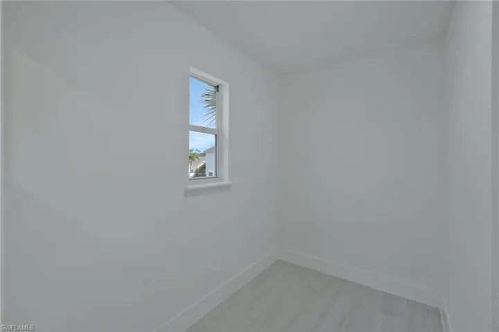 Unfurnished room with baseboards and light wood-style flooring