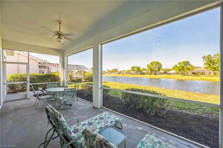 Sunroom featuring a water view and ceiling fan
