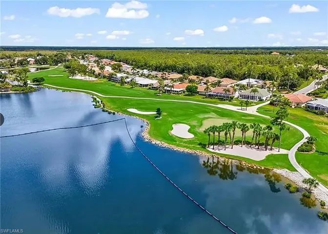 Birds eye view of property with a water view