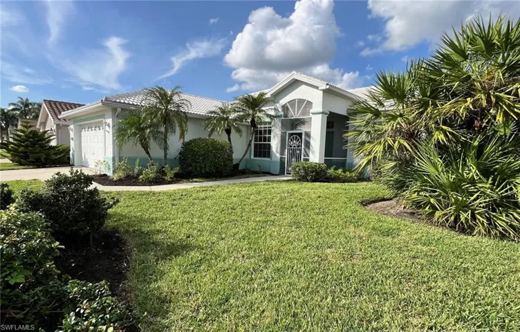 View of front facade with a front yard and a garage