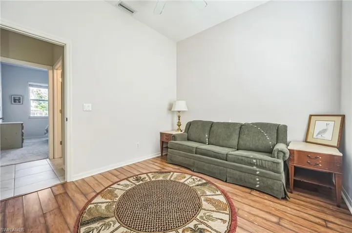 Living room featuring ceiling fan and wood-type flooring