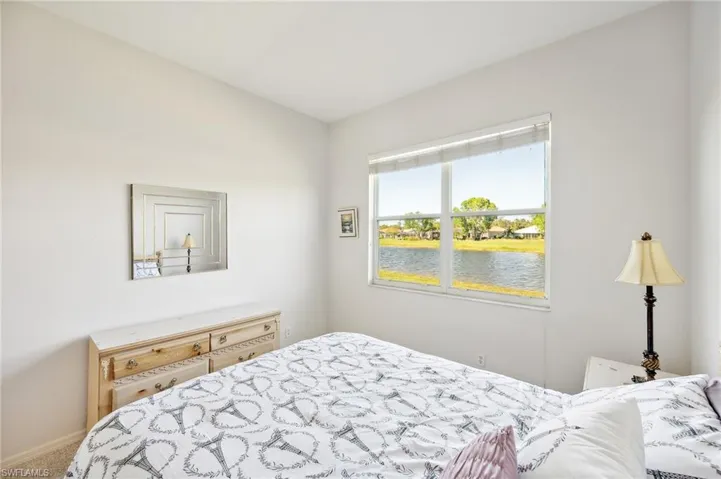 Carpeted bedroom featuring a water view