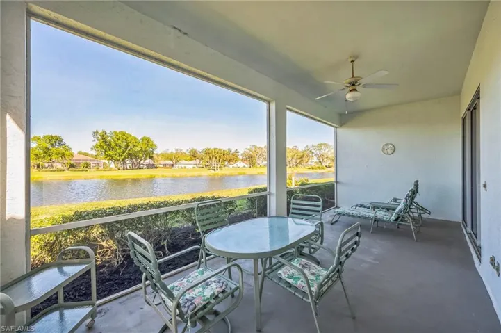 Unfurnished sunroom featuring ceiling fan and a water view
