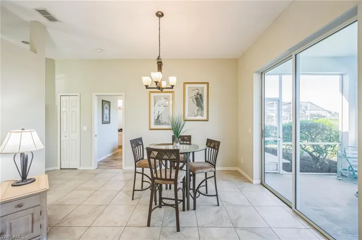 Tiled dining area with a notable chandelier