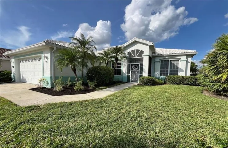 View of front facade with a front yard and a garage
