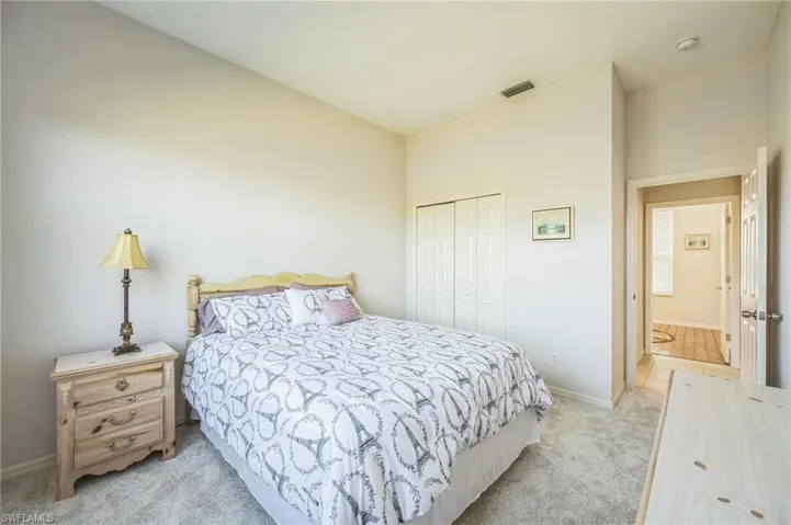 Bedroom featuring light colored carpet and a closet