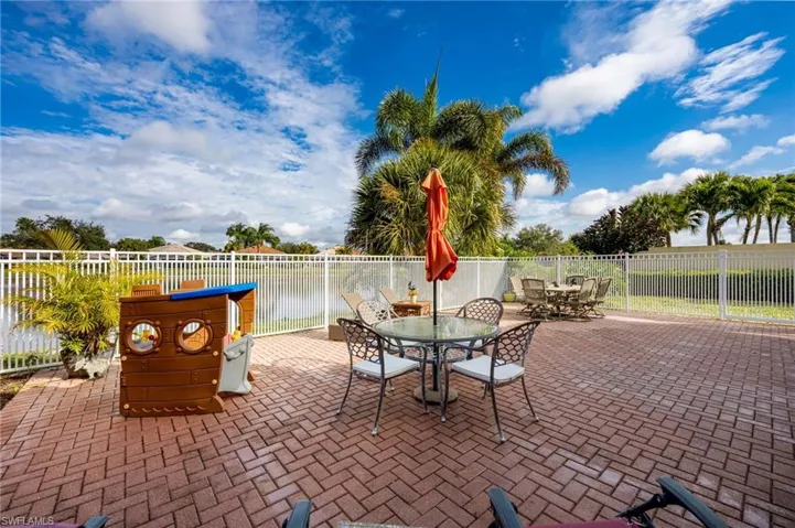 Fenced backyard with outdoor dining space and a patio
