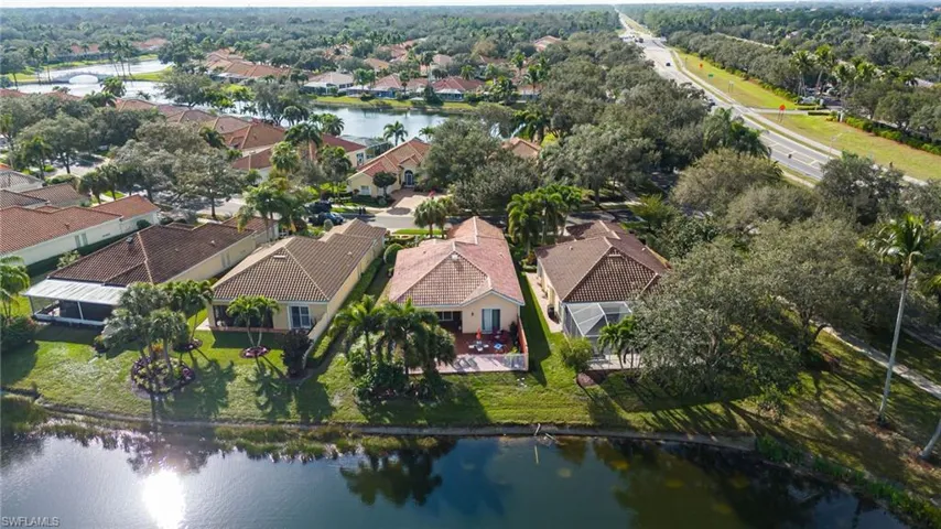 Aerial perspective of suburban area featuring a nearby body of water