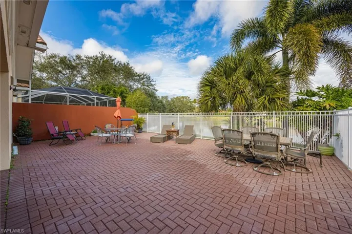 Fenced backyard featuring outdoor dining area, a patio, and a sunroom