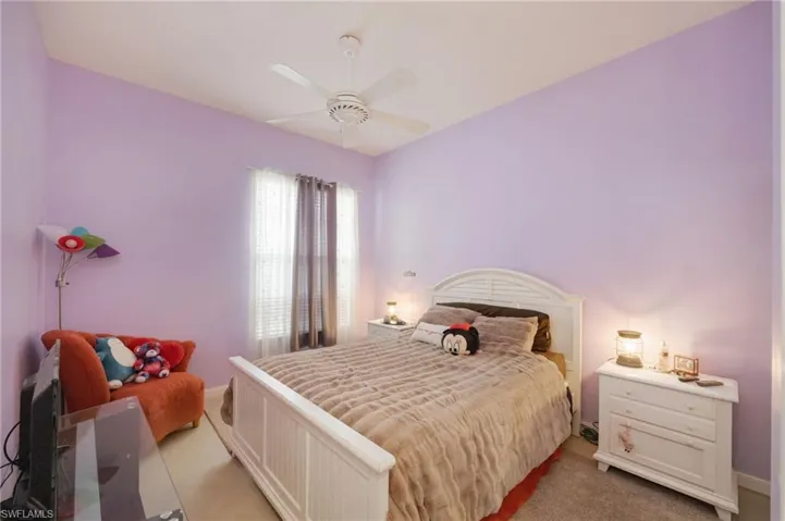 Bedroom with ceiling fan and carpet floors