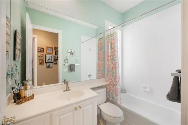 Bathroom featuring shower / bath combo and vanity