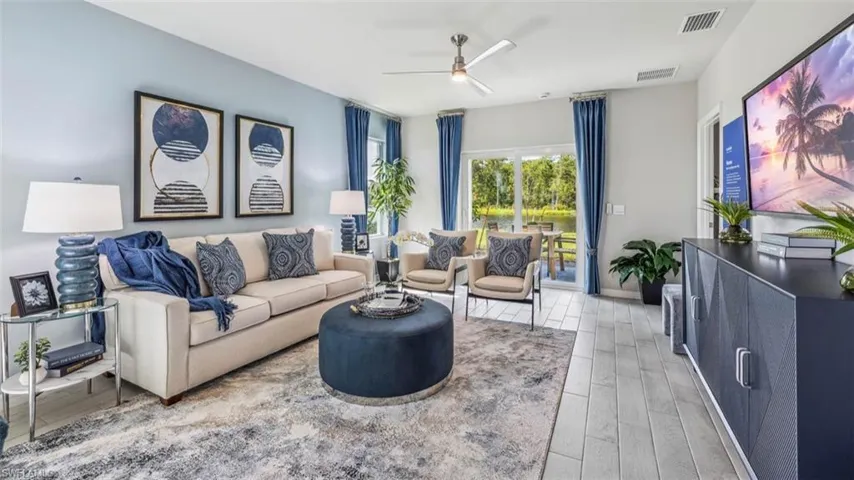 Living room with a ceiling fan and light wood-style floors