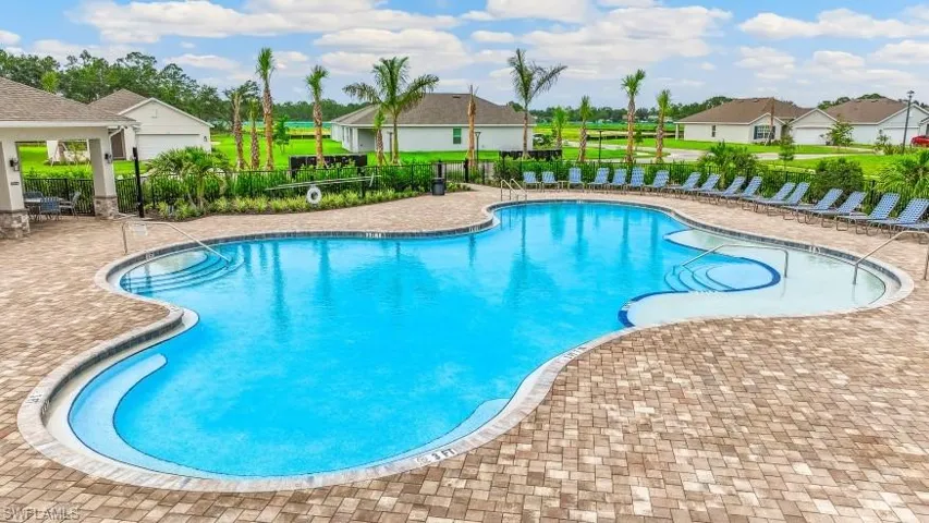 Community pool featuring a residential view and a patio area