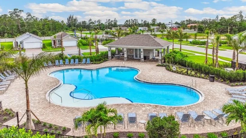 Community pool with a patio and a residential view