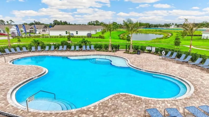 Community pool featuring a patio and a water view