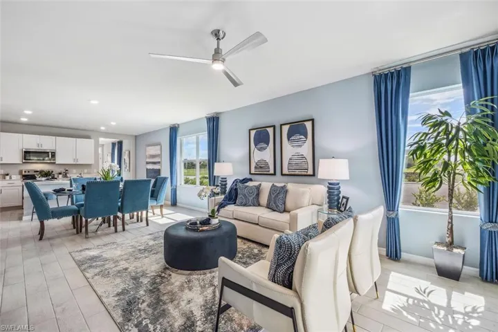 Living room featuring ceiling fan, baseboards, and recessed lighting