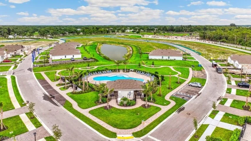 Aerial view of a pool area and a nearby body of water