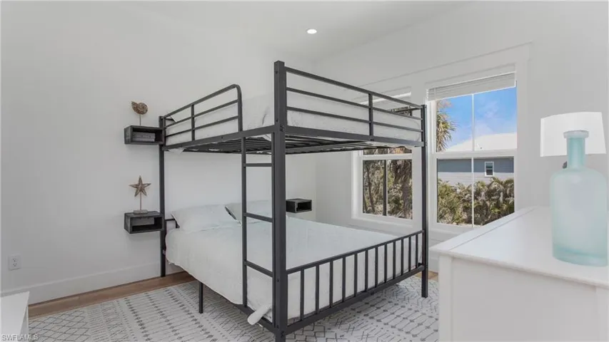 Bedroom with light wood-style floors and baseboards