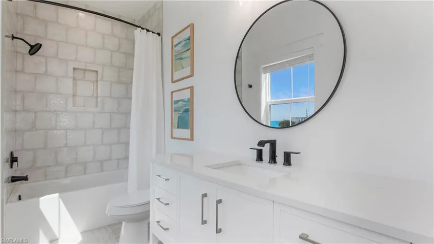 Bathroom featuring vanity and shower / tub combo