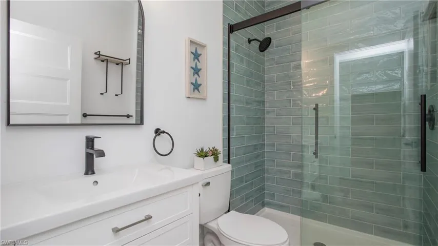 Bathroom with vanity and tiled shower