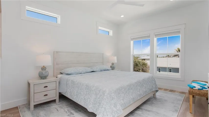 Bedroom featuring multiple windows, light wood-style floors, recessed lighting, and a ceiling fan