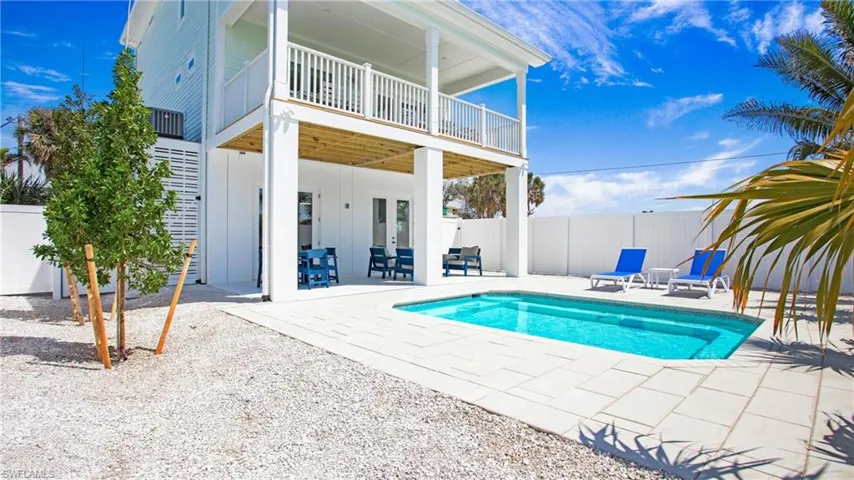 View of pool featuring a patio area, a fenced backyard, and french doors