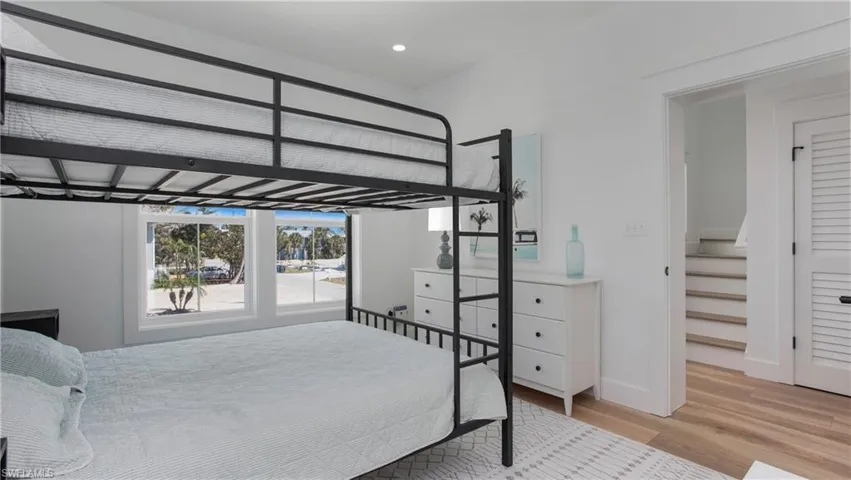 Bedroom with wood finished floors and recessed lighting