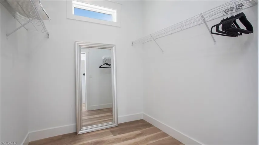 Walk in closet featuring light wood finished floors