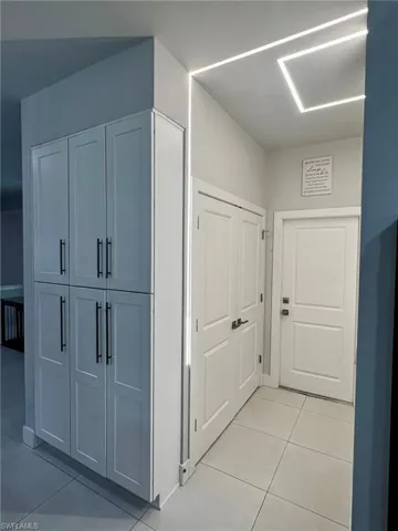 Corridor with light tile patterned floors
