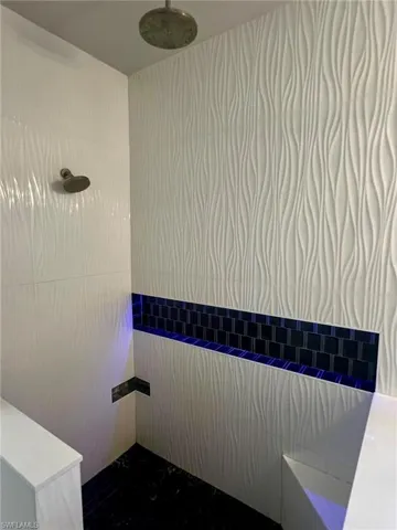 Bathroom view of a tile shower