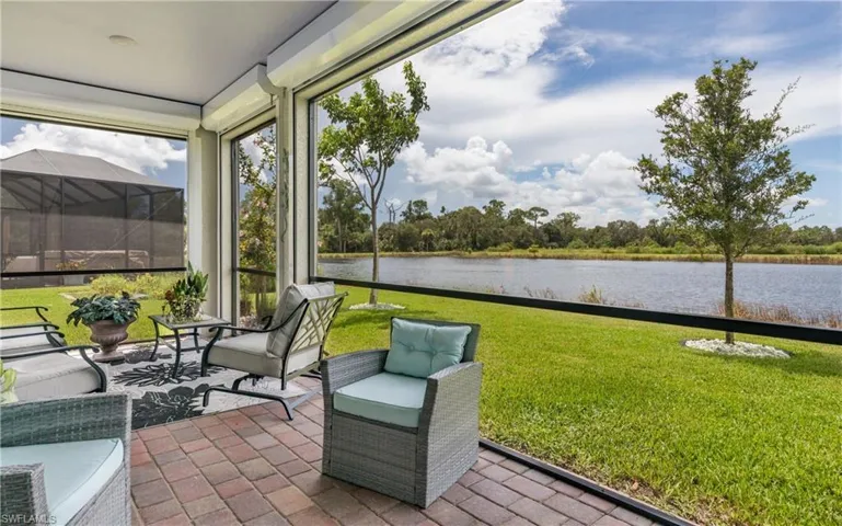Sunroom featuring a water view