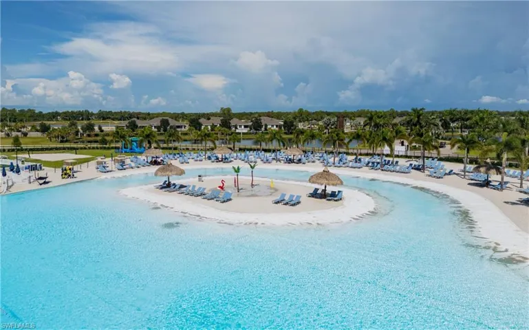 Aerial view of a pool area and a nearby body of water