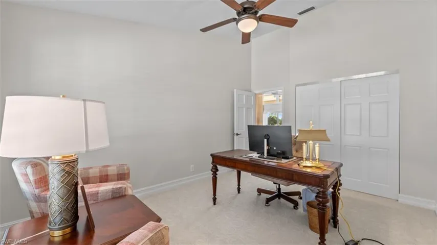 Vaulted ceiling room with light-toned wall paint and neutral carpeting-- with closet for a 4th bedroom